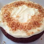 Cake Topped with creamy icing and Toasted coconut.